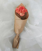 Orange carnation in brown kraft cone wrap